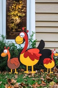 Three vibrant turkey yard decorations strut their stuff on the lawn, turning your standard grass patch into a feathered fiesta. Who knew gobblers had such flair?