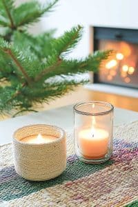 Okay, so imagine two mood-setting candles cozying up to a baby pine tree, all while your fireplace does its warm-and-toasty magic in the background. Holiday goals, right?
