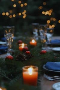 Imagine your table got all dressed up for the holidays, with candles, pinecones, and red ornaments. It's like a winter wonderland crashed your dinner party!