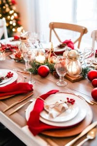 Alright, check this out: It's a holiday table that shaved its legs! Rocking red and white, candles, lanterns, and enough ornaments to make Santa jealous!