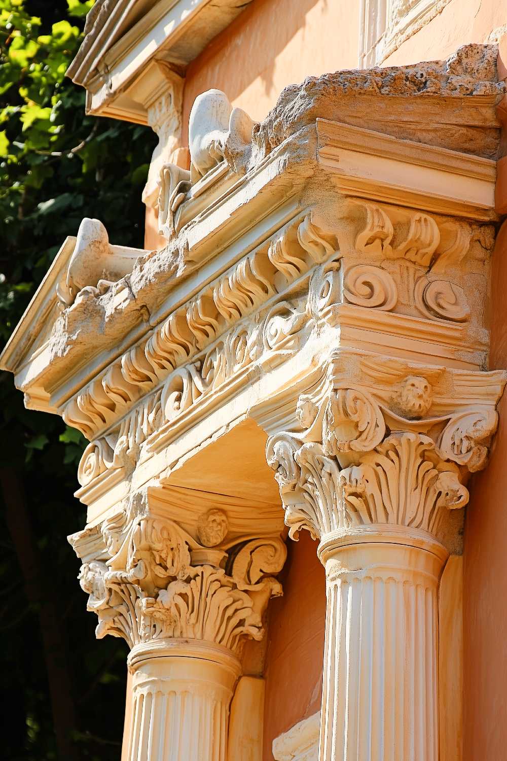 Check out these fancy columns and intricate details soaking up some rays, framed by Mr. Tree over here just casually photobombing the architecture.
