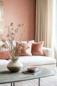Meet your new living room muse: the sophisticated white sofa, enhanced by feisty pink cushions. Those twigs in a vase? They're the rebels of minimalism!