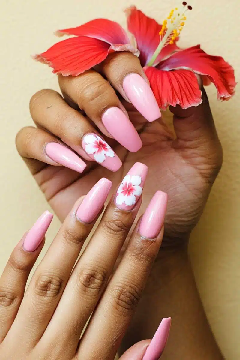 Feast your eyes on these manicured wonders with hibiscus flair as they flaunt a red bloom against beige. Its like a tropical vacay for your fingers!.