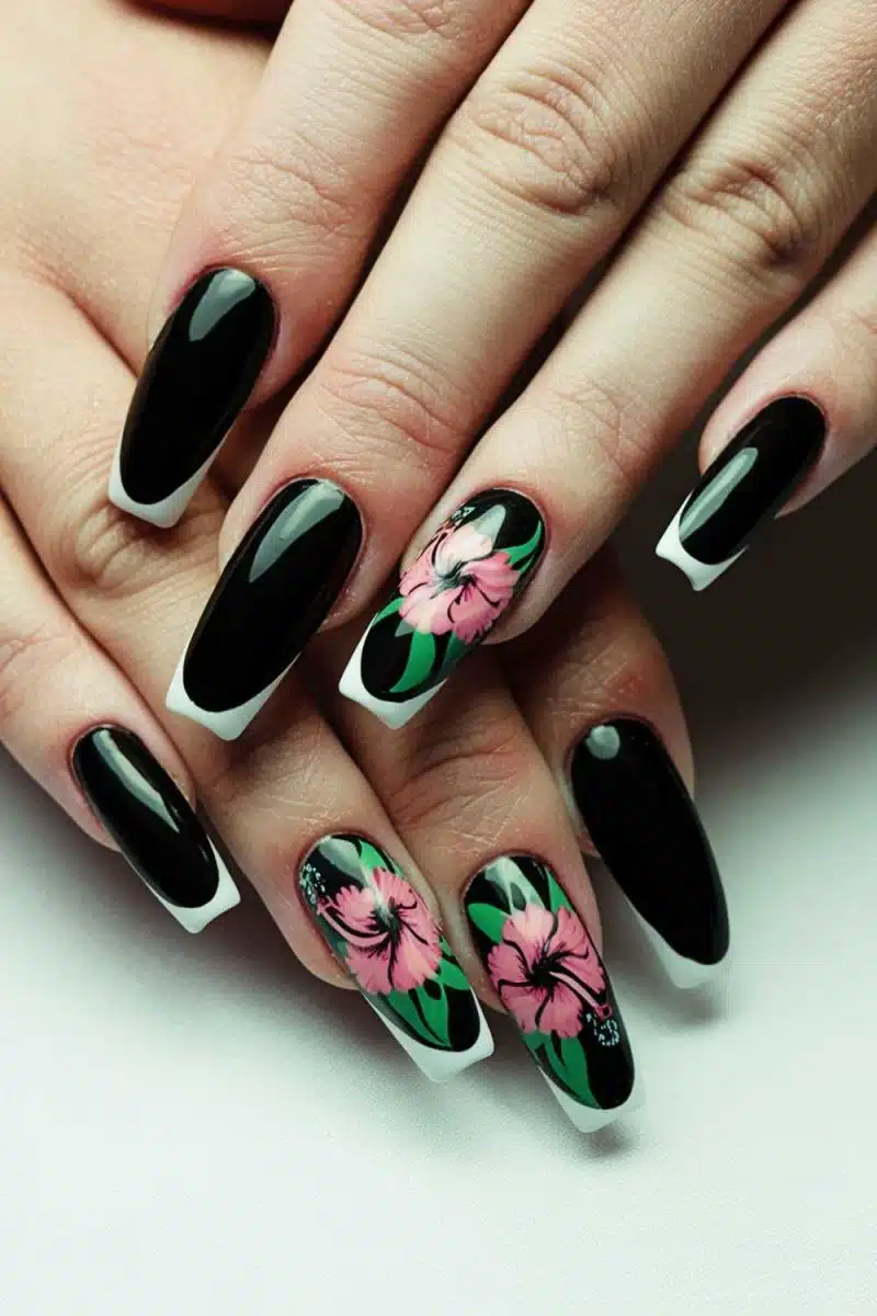 Say hello to the ultimate manicure masterpiece: long black nails with pink hibiscus art and white accents that whisper tropical vacay but in a goth way.