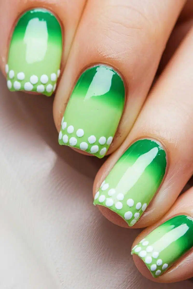Nails sporting a green gradient polish like a fresh forest dew, with white dotted tips that could double as Morse code for I nail this look daily.
