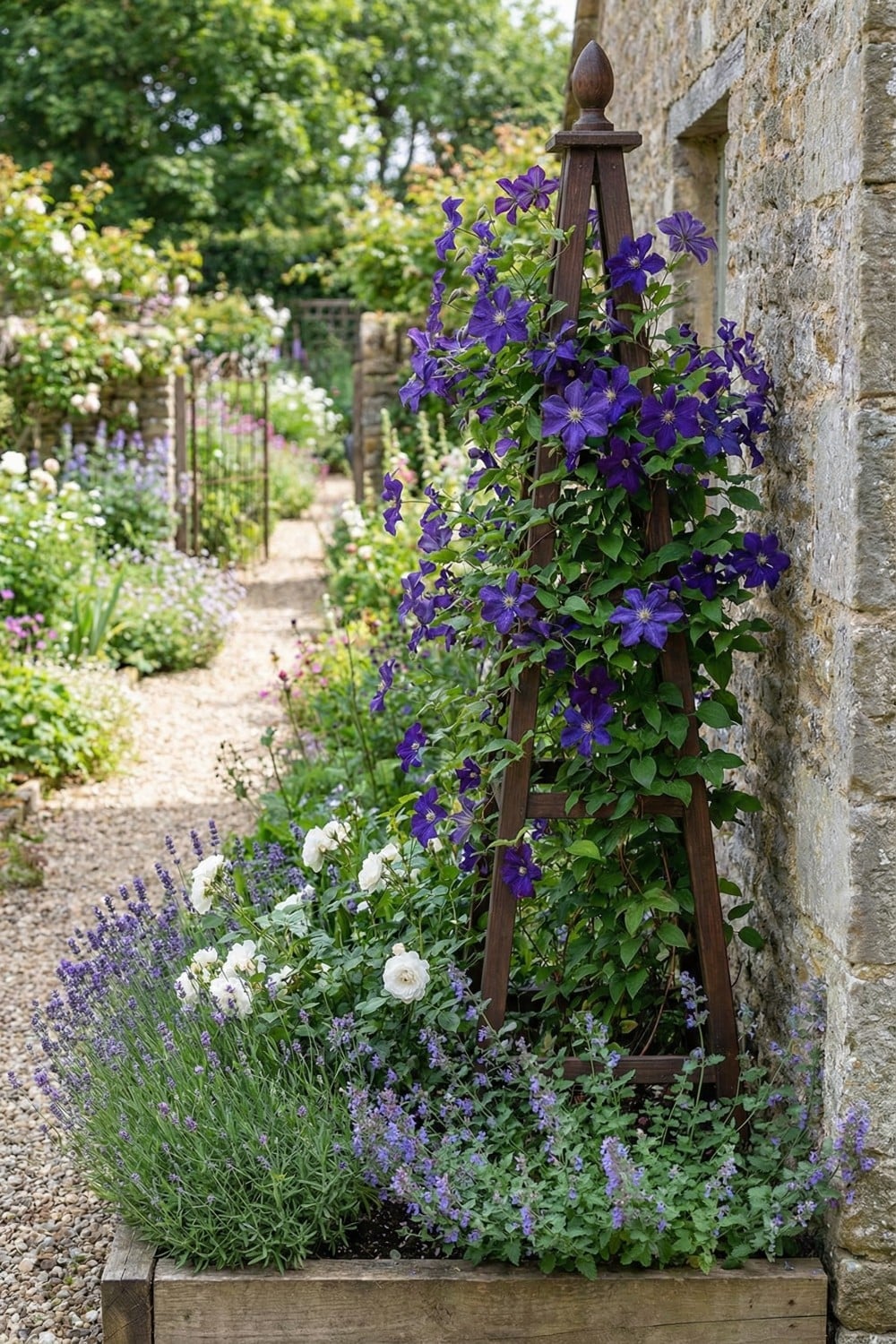 Obelisk clematis trellis with indigo flowers and finial