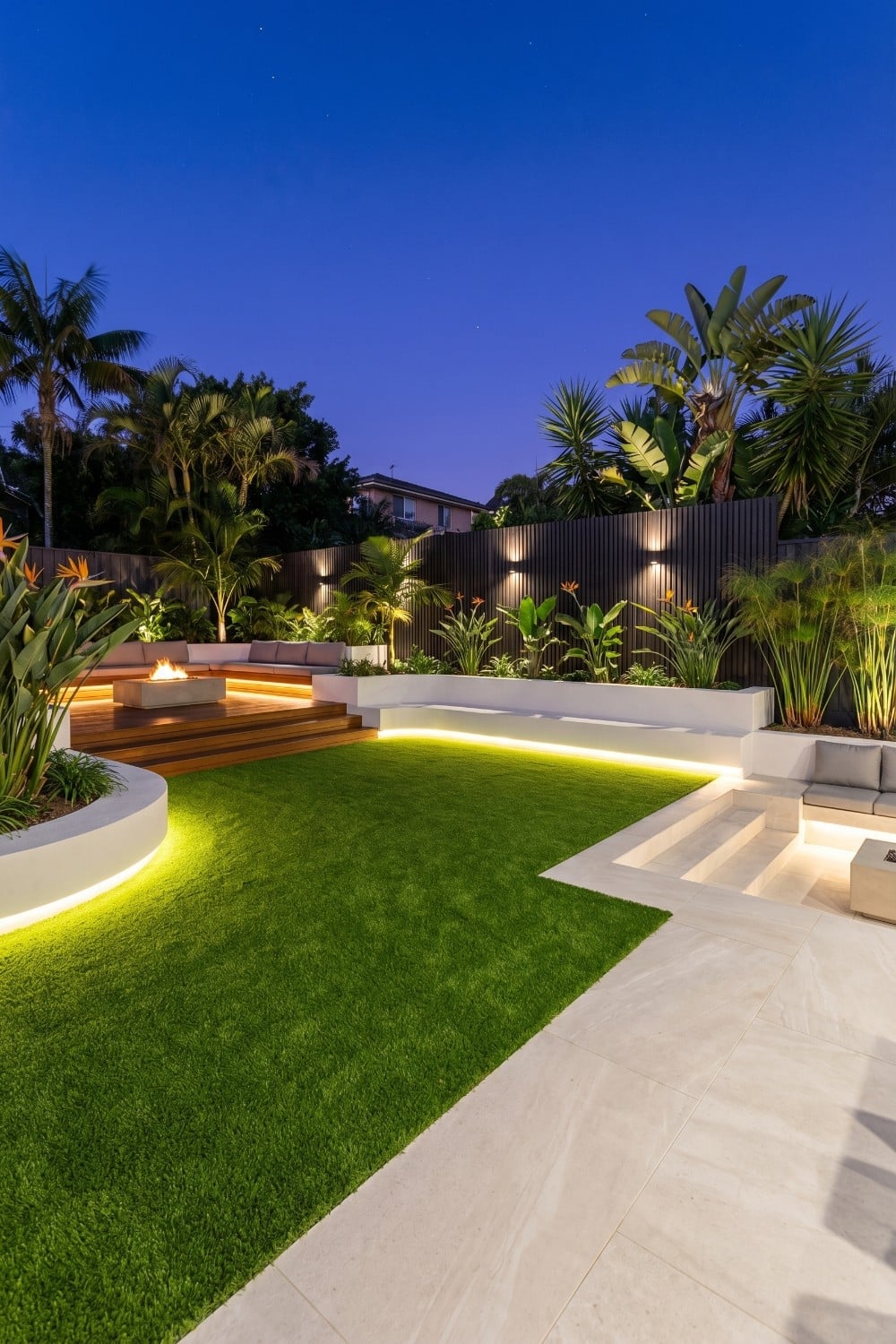 Artificial Grass Backyard with Illuminated White Retaining Walls